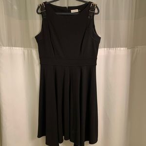 Black cocktail dress with gold buckle accents